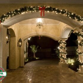 white holiday lights on wreath wrapping residential homes columns